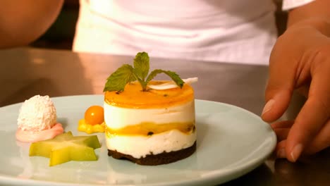 hands of a chef preparing dessert food