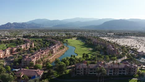 rising aerial reverse pullback shot of a palm desert resort