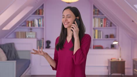 Happy-Indian-woman-talking-to-someone-on-call