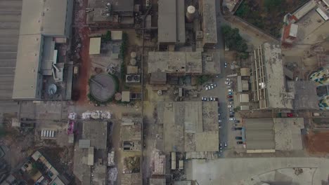 top shot of a refinery and a factory, bombay, india, showing roofs of the factory, cars parked at outside of the factory