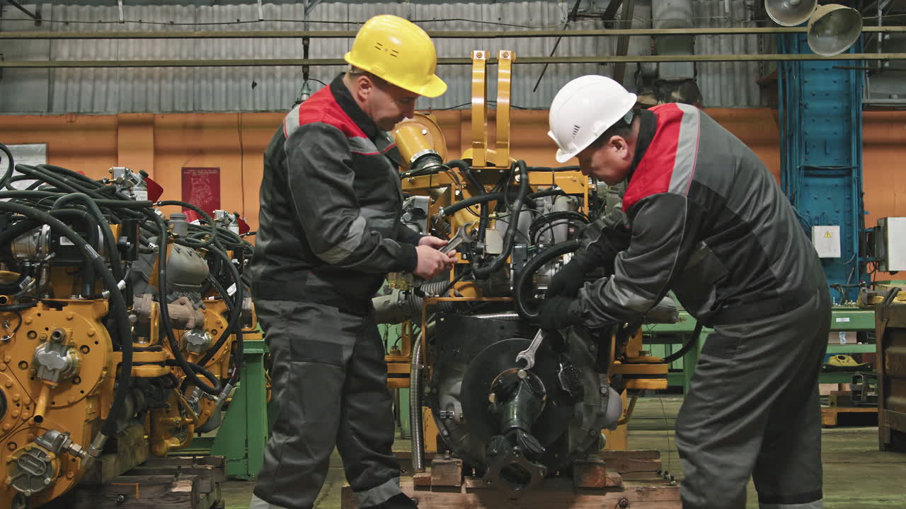 Plant Workers Fixing Machinery Equipment
