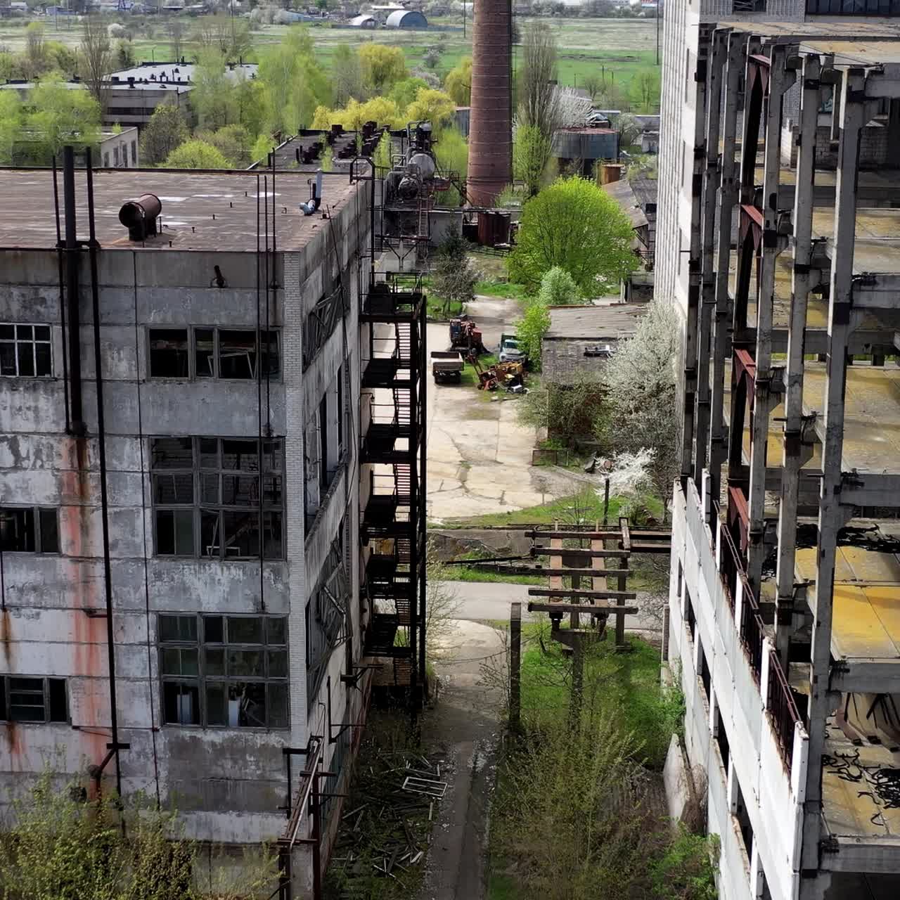 Old industrial buildings. Ruined factory buildings of industry. Empty abandoned place. Aged industrial edifices