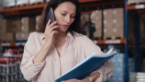 Caucasian-elegance-woman-talking-by-mobile-phone-in-warehouse.