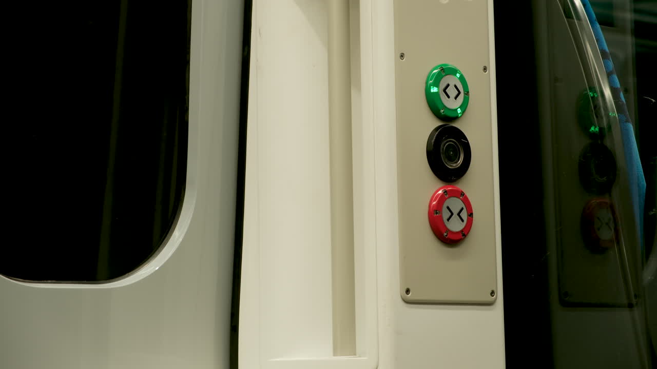 Close-up of the open and close door button on a Northern Rail train, highlighting the functional details and design of public transport