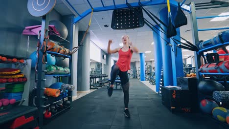 front view of a sportswoman indoors. sportive girl training her body in fitness centre. girl doing exercises on sports club background.