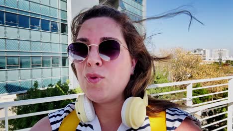 the traveler, just arrived, takes selfies and videos on a pedestrian bridge.