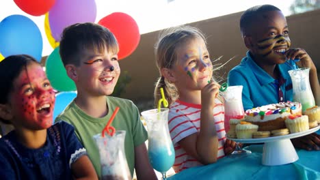 kids having sweet food and drinks in the playground 4k