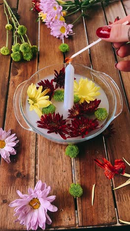 floral candle arrangement on wooden table