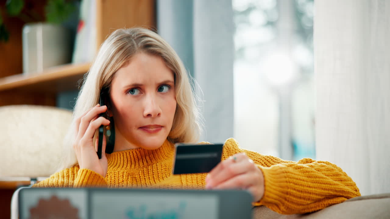 Woman using credit card and phone for online transaction