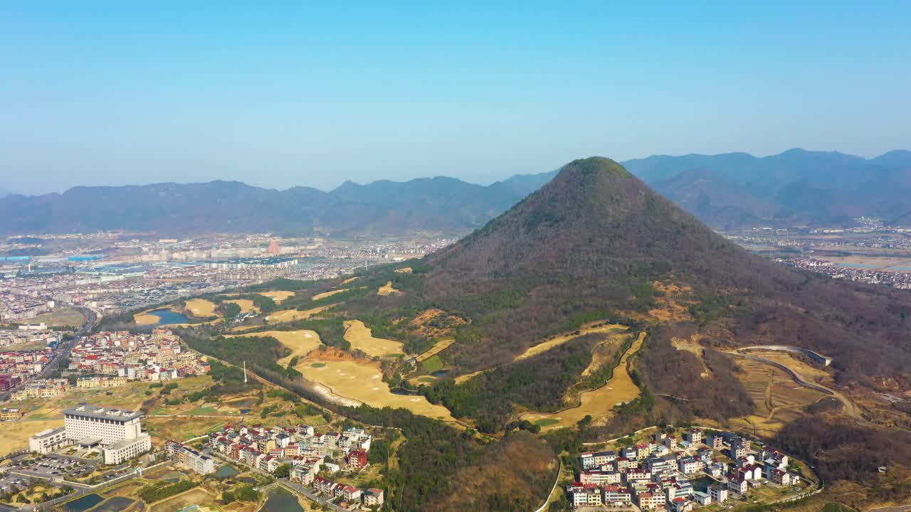 Aerial: landscape view during the day of mountain and cityscape in Chizhou City, Anhui Province, China, establishing drone shot