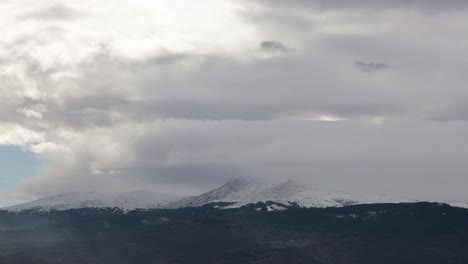 mountains time lapse of clouds passing over the snowy mountain top