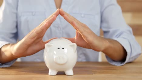 woman gesturing on piggy bank