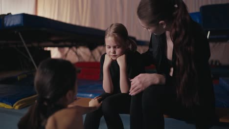 young girl training with her coach in a gym