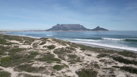 drone flying over blouberg beach with table mountain in the background