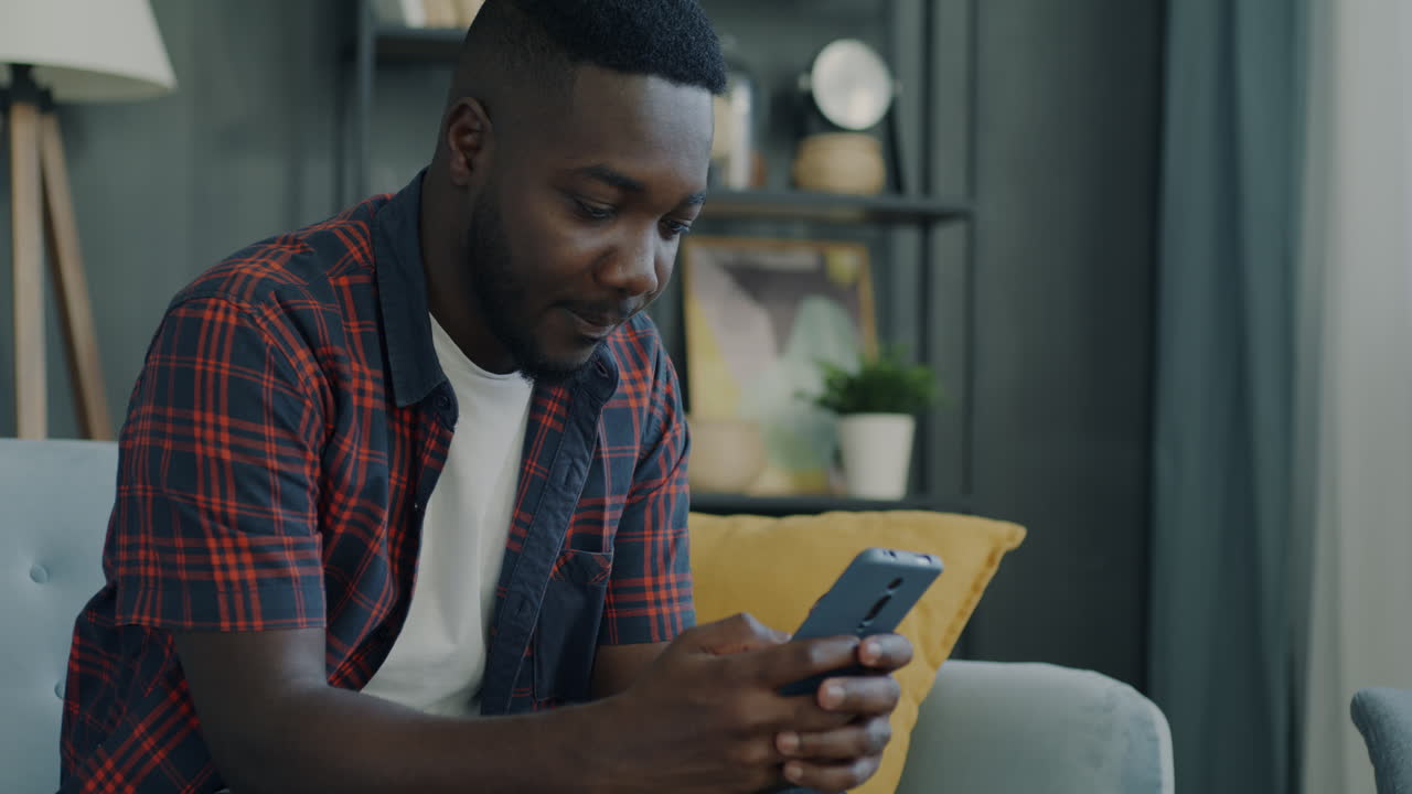 Man using a smartphone at home