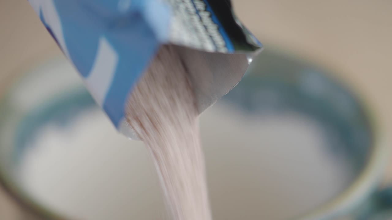 Pouring drink mix into a mug
