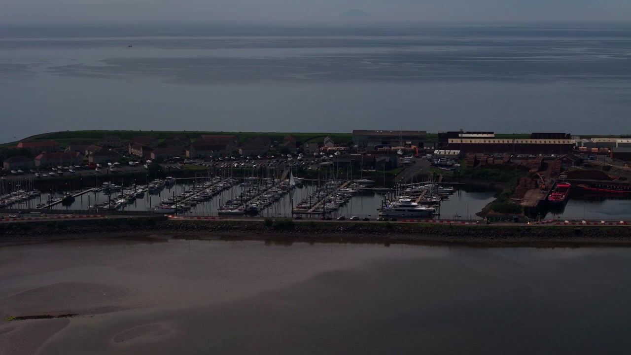 Troon Marina i Ayrshire, Skottland, visar förtöjda yachter, hamnanläggningar och lugna kustvatten i skymningen, flygvy.