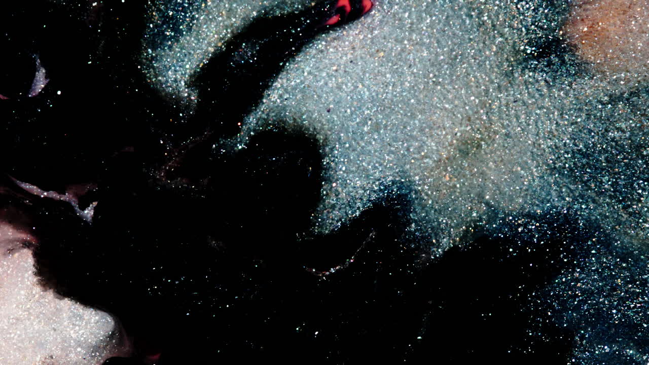 Colorful liquid textures mixing in macro view with a dreamy, cosmic look