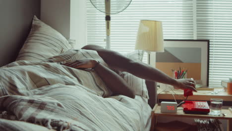 African-American-Man-Waking-Up-in-Bed-and-Answering-Phone-Call