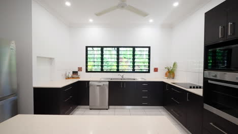 expansive open island kitchen with black cabinet and stainless steel appliances