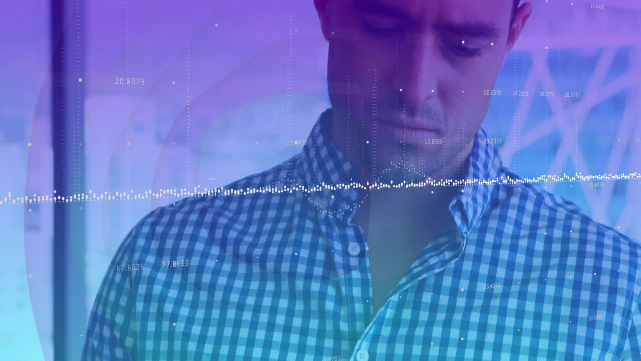 Man analyzing finance dashboard in tech workspace, with animated waveform and floating numbers