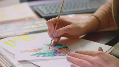 Young-graphic-designer-working-on-modern-desktop-computer-while-using-graphic-tablet-at-desk-in-the-office.