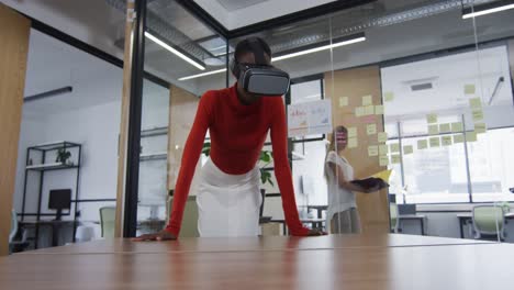 african american woman wearing vr headset at modern office