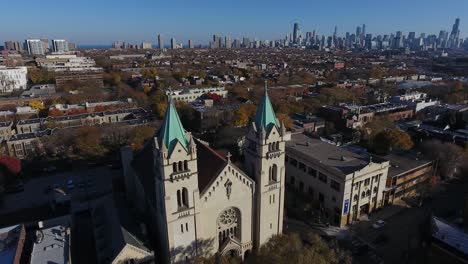 Chicago-USA,-Aerial-View-of-St-Josaphat-Catholic-Church-and-Downtown-Towers-in-Background-on-Sunny-Autumn-Day,-Drone-Shot