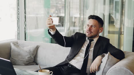 Businessman taking a video call in a cafe