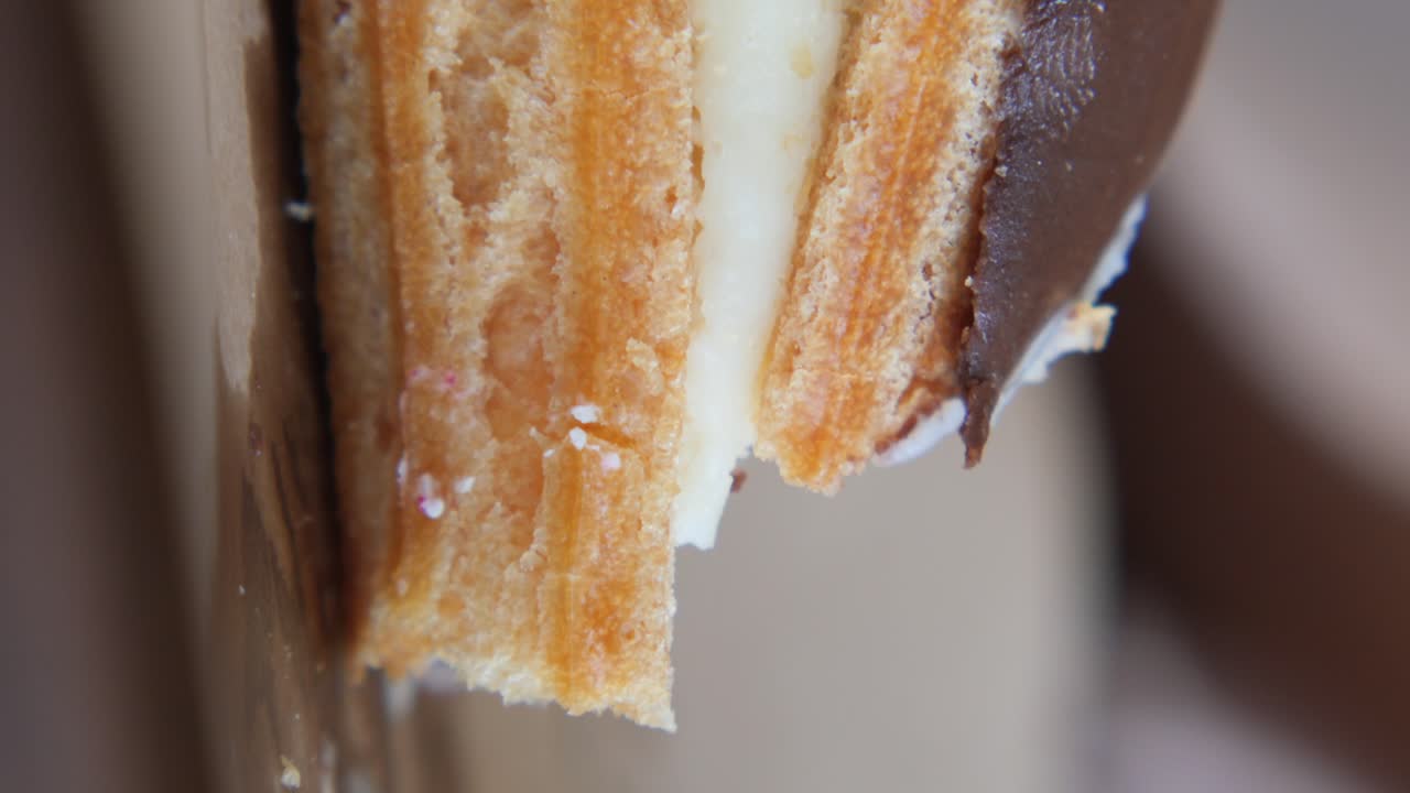 Close-up of a delicious pastry with cream and chocolate filling