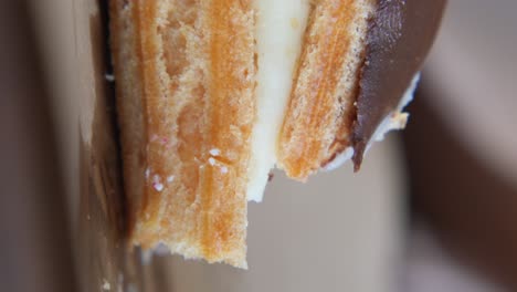 close-up of a delicious pastry with cream and chocolate filling