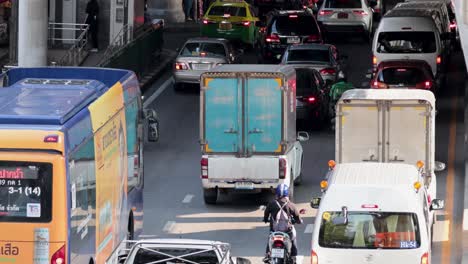 vehicles and motorbikes navigating congested city road