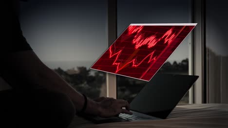 red stock market crash graph displayed above a laptop