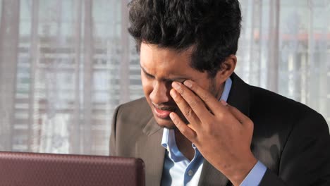 stressed businessman working on laptop