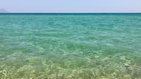 Stunning-turquoise-Greek-Mediterranean-seascape-and-view-on-sacred-Athos-mountain-across-in-4k