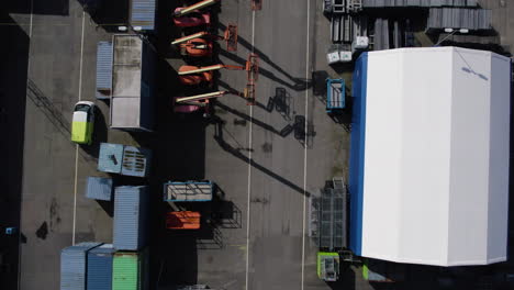 cherry picker aerial work platforms parked at outside, top down aerial