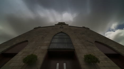 time lapse of a historical church in ireland during the day with passing clouds