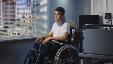 injured teenager in hospital wheelchair