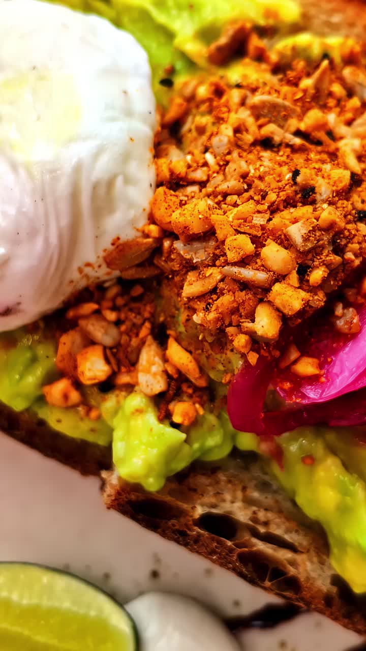 A Flavorful Avocado Toast Topped With a Poached Egg Makes the Perfect Breakfast in Lombok, Indonesia - Vertical Shot