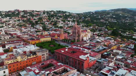 Daytime-Aerial-Orbit-In-San-Miguel-De-Allende-City-Centre-Looking-Over-El-Campanario,-Parroquia-De-San-Miguel-Arcangel-And-Jardin-Allende