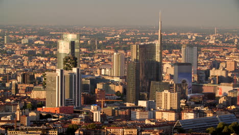 milan city skyline glow during sunset, aerial view