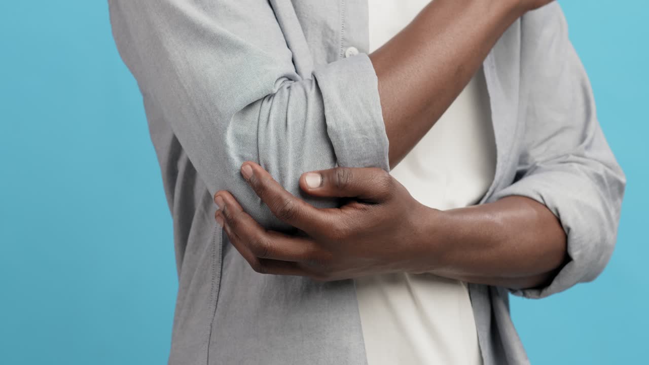 Man holding painful elbow