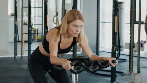 woman exercising on a spin bike in a gym