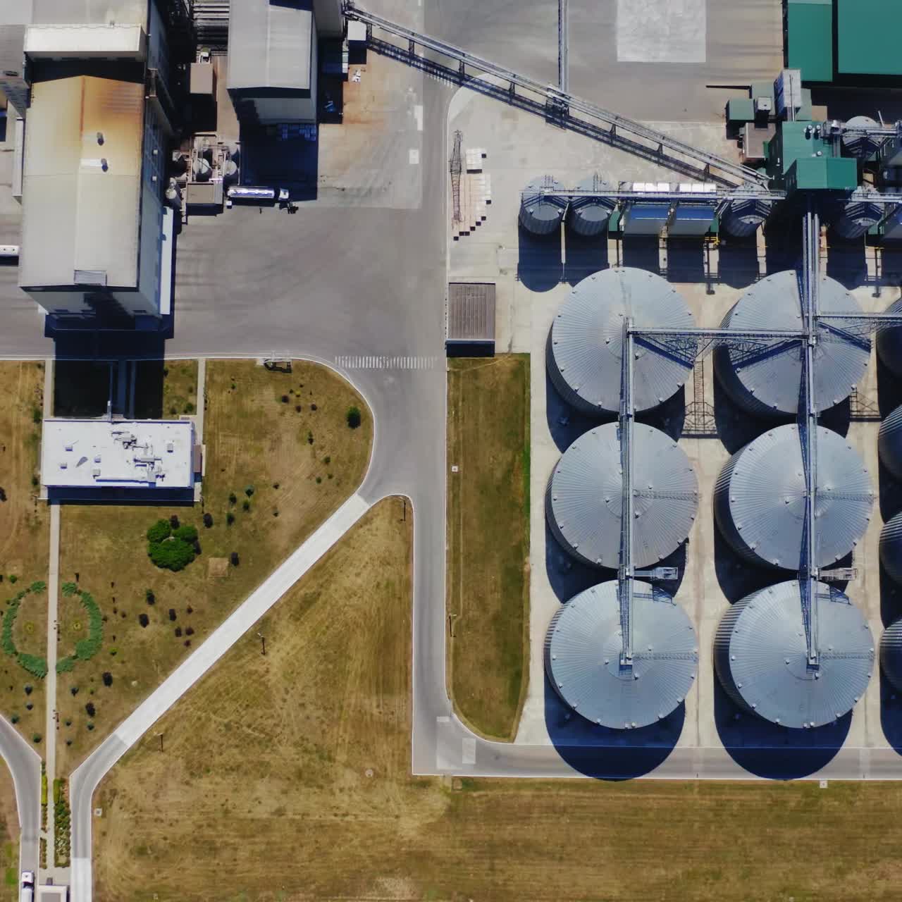 Warehouse granary aluminum containers. Grain silo and parking place. Steel grain elevators. Agriculture Industry. Top view.