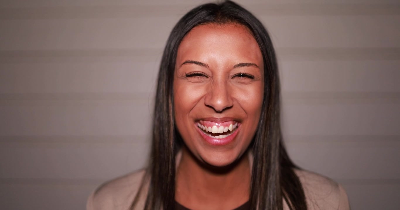 Smiling Woman with Eyes Closed Laughing Joyfully