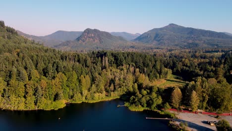 Magnificent-Green-Forest-In-Mineral-Lake-Resort,-Large-Mountains-In-Background,-Washington