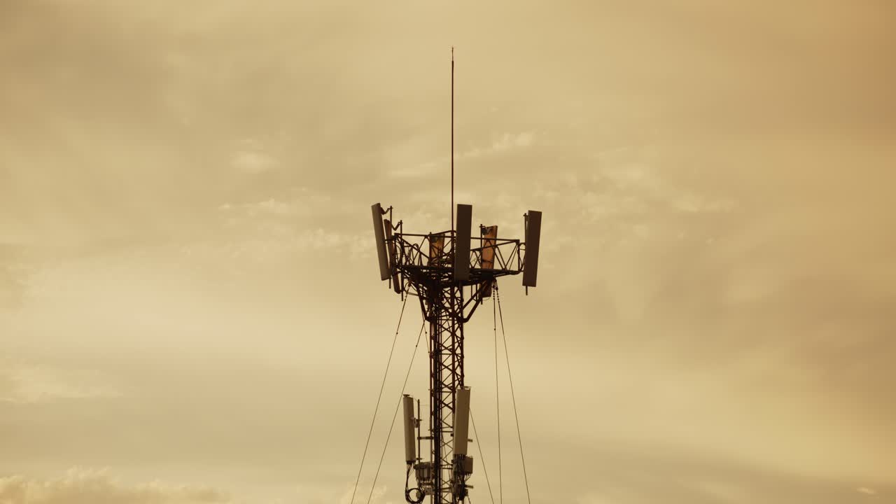5G communication tower in Buenos Aires with a moody sunset sky in the background