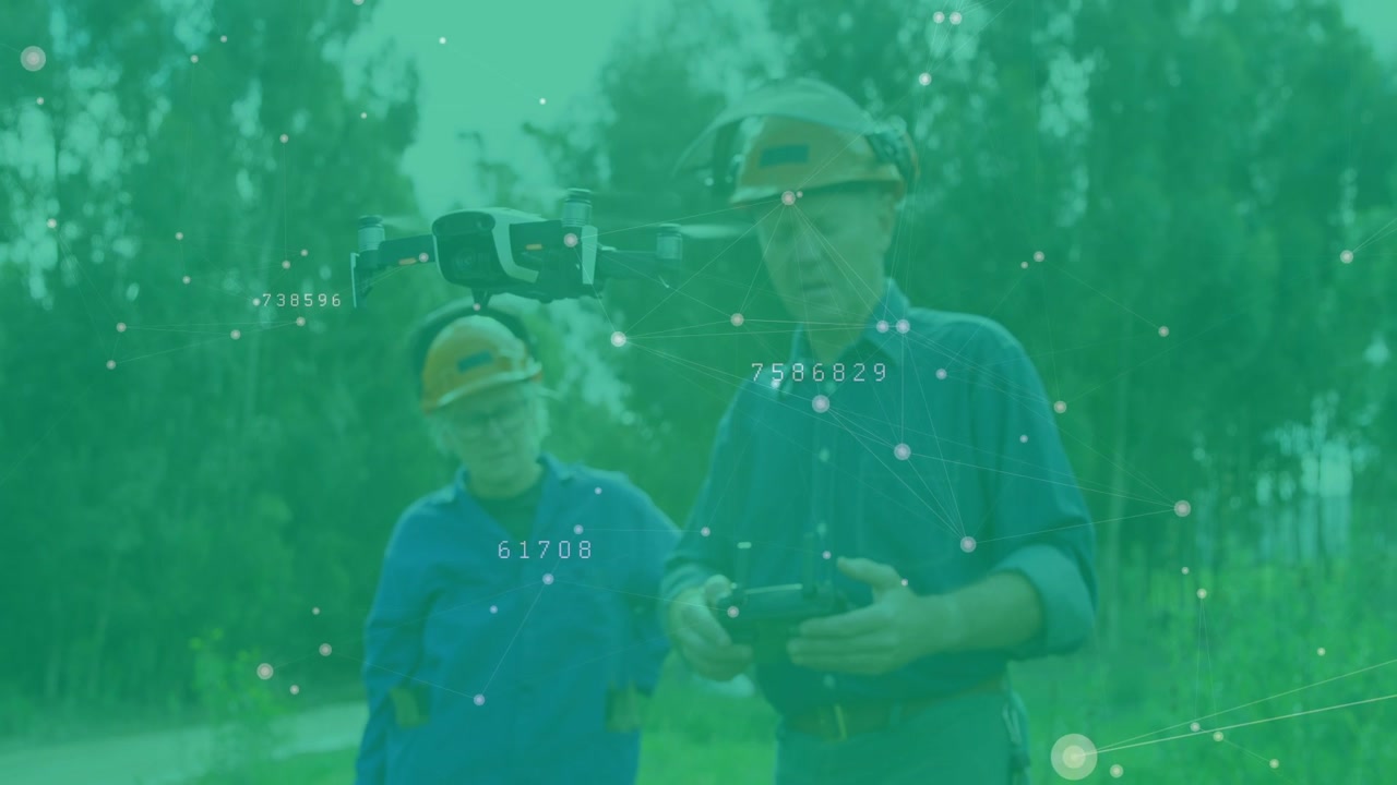 Male operator operating remote while female tech monitoring drone with AR readouts for inspection