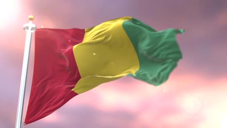 flag of guinea waving at wind in slow at sunset, loop
