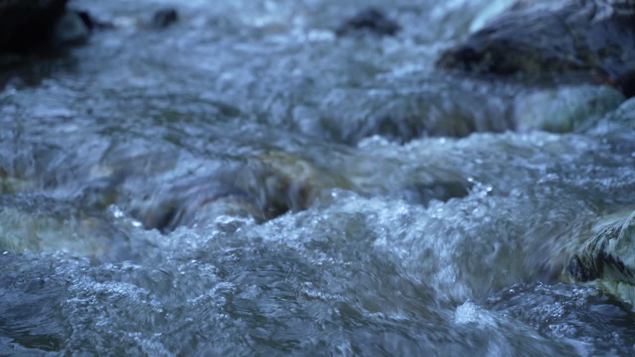 Water is flowing through a mountain torrential river.